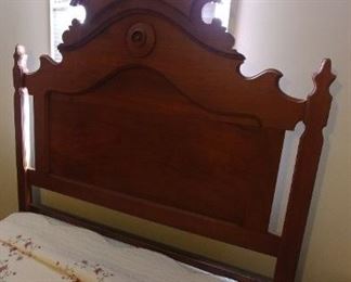 Headboard closeup of walnut Victorian high back bed