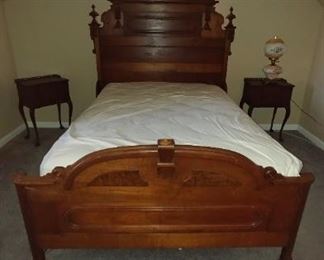 Victorian high back bed is walnut with burl