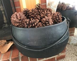 Large cast iron pot filled with pine cones