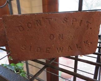 'Don't spit on the sidewalk' brick
