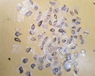 approximately 100 polished Stone pendants