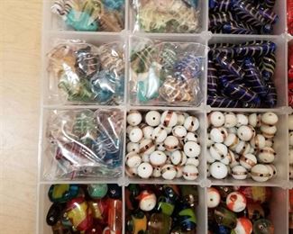 two organizer containers full of fancy necklace beads and glass necklace beads