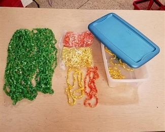 large lot of assorted beaded strands - green yellow and orange