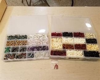 2 storage organizers full of assorted pendants and jewelry beads