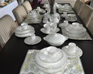 Royal Doulton Twilight Rose service for 12 including serving pieces sitting on a black dining table measuring 36” x 80” including the two 18” leaves, Ikea upholstered Parsons dining chairs (6)