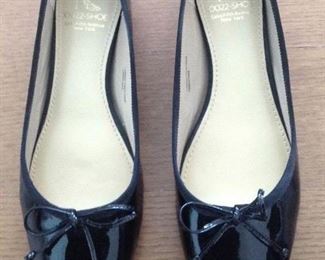 SAKS FIFTH AVENUE BLACK PATENT LEATHER FLATS WITH BOW AND 1/2" COVERED WEDGE: Size: 6.5. Grosgrain ribbon detail. Condition: Very good. Price: $100.
