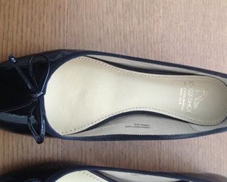 SAKS FIFTH AVENUE BLACK PATENT LEATHER FLATS WITH BOW AND 1/2" COVERED WEDGE: Size: 6.5. Grosgrain ribbon detail. Condition: Very good. Price: $100.