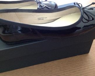 SAKS FIFTH AVENUE BLACK PATENT LEATHER FLATS WITH BOW AND 1/2" COVERED WEDGE: Size: 6.5. Grosgrain ribbon detail. Condition: Very good. Price: $100.