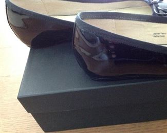 SAKS FIFTH AVENUE BLACK PATENT LEATHER FLATS WITH BOW AND 1/2" COVERED WEDGE: Size: 6.5. Grosgrain ribbon detail. Condition: Very good. Price: $100.