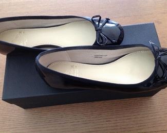 SAKS FIFTH AVENUE BLACK PATENT LEATHER FLATS WITH BOW AND 1/2" COVERED WEDGE: Size: 6.5. Grosgrain ribbon detail. Condition: Very good. Price: $100.