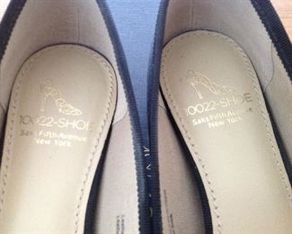 SAKS FIFTH AVENUE BLACK PATENT LEATHER FLATS WITH BOW AND 1/2" COVERED WEDGE: Size: 6.5. Grosgrain ribbon detail. Condition: Very good. Price: $100.
