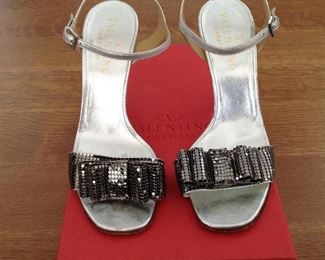 VALENTINO GARAVANI SILVER METALLIC LEATHER WITH SILVER METALLIC MESH BOWS OPEN-TOE SHOES: Size 37. Heel Height: 4 inches. Condition: Very good. Light scratches on heels. Price: $200.