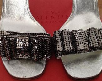 VALENTINO GARAVANI SILVER METALLIC LEATHER WITH SILVER METALLIC MESH BOWS OPEN-TOE SHOES: Size 37. Heel Height: 4 inches. Condition: Very good. Light scratches on heels. Price: $200.