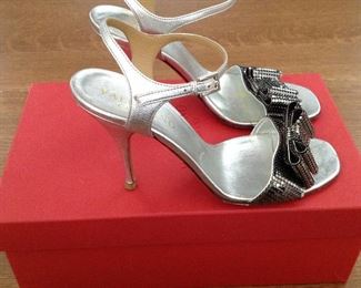 VALENTINO GARAVANI SILVER METALLIC LEATHER WITH SILVER METALLIC MESH BOWS OPEN-TOE SHOES: Size 37. Heel Height: 4 inches. Condition: Very good. Light scratches on heels. Price: $200.