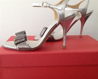 VALENTINO GARAVANI SILVER METALLIC LEATHER WITH SILVER METALLIC MESH BOWS OPEN-TOE SHOES: Size 37. Heel Height: 4 inches. Condition: Very good. Light scratches on heels. Price: $200.