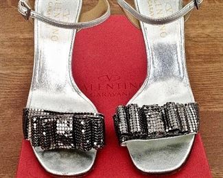VALENTINO GARAVANI SILVER METALLIC LEATHER WITH SILVER METALLIC MESH BOWS OPEN-TOE SHOES: Size 37. Heel Height: 4 inches. Condition: Very good. Light scratches on heels. Price: $200.
