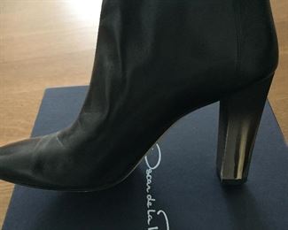 OSCAR DE LA RENTA BLACK LEATHER ANKLE BOOTS: Size 8 or 38.. Round-toe ankle boots with black matte and metal tone ombre block heels. Size 8 or 38. Heel Height: 3.5 inches. Condition: Good. Light scratches on toe, body and heels. Retail value: $890. Price: $200.