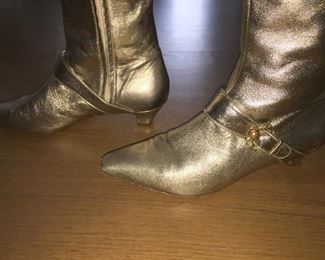 SALVATORE FERRAGAMO METALLIC GOLD-TONE LEATHER KNEE-HIGH BOOTS WITH RHINESTONE/PEARL EMBELLISHMENT: Size 7. Tonal strap accents at ankles. Covered heels and zipper closures at instep. Pink leather interior. Calf circumference: 13 inches. Shaft: 14.5 inches. Heel Height: 1.25 inches. Condition: Good. Faint scuffs and blemishes throughout. Price: $200.