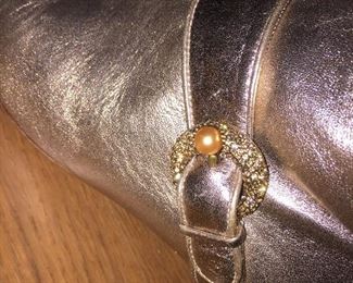 SALVATORE FERRAGAMO METALLIC GOLD-TONE LEATHER KNEE-HIGH BOOTS WITH RHINESTONE/PEARL EMBELLISHMENT: Size 7. Tonal strap accents at ankles. Covered heels and zipper closures at instep. Pink leather interior. Calf circumference: 13 inches. Shaft: 14.5 inches. Heel Height: 1.25 inches. Condition: Good. Faint scuffs and blemishes throughout. Price: $200.