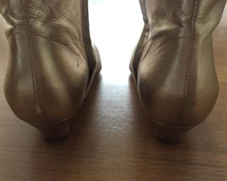 SALVATORE FERRAGAMO METALLIC GOLD-TONE LEATHER KNEE-HIGH BOOTS WITH RHINESTONE/PEARL EMBELLISHMENT: Size 7. Tonal strap accents at ankles. Covered heels and zipper closures at instep. Pink leather interior. Calf circumference: 13 inches. Shaft: 14.5 inches. Heel Height: 1.25 inches. Condition: Good. Faint scuffs and blemishes throughout. Price: $200.