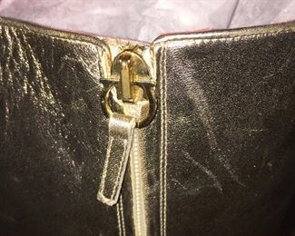 SALVATORE FERRAGAMO METALLIC GOLD-TONE LEATHER KNEE-HIGH BOOTS WITH RHINESTONE/PEARL EMBELLISHMENT: Size 7. Tonal strap accents at ankles. Covered heels and zipper closures at instep. Pink leather interior. Calf circumference: 13 inches. Shaft: 14.5 inches. Heel Height: 1.25 inches. Condition: Good. Faint scuffs and blemishes throughout. Price: $200.
