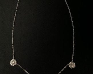 DIAMOND FLEURETTE 18 KT WHITE GOLD AND 1.64 CARAT DIAMOND NECKLACE: LOTS OF FIRE AND SPARKLE.
Signed appraisal report included. Gift Box Included.
One stamped and tested 18KT white gold lady's hand assembled three diamond cluster necklace with a shared prong set.
18KT white gold lobster clasp and bright polish finish.
Identified with markings of "18kt/750".
Condition: Excellent. Light scratches on metal.
Total Weight of Diamonds: 1.64 ct.
Total Weight of Three Diamond Cluster Necklace: 6.00 gm.
Three shared prong set round brilliant cut diamonds exact total weight of 3 stones = 0.52 ct.
Clarity: VS. Color: F. Cut: Excellent
Twenty-four shared prong set round brilliant cut diamonds exact total weight 24 stones = 1.12ct.
Clarity VS. Color: F-G. Cut: Excellent.
Price: $2,900