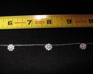 DIAMOND FLEURETTE 18 KT WHITE GOLD AND 1.64 CARAT DIAMOND NECKLACE: LOTS OF FIRE AND SPARKLE.
Signed appraisal report included. Gift Box Included.
One stamped and tested 18KT white gold lady's hand assembled three diamond cluster necklace with a shared prong set.
18KT white gold lobster clasp and bright polish finish.
Identified with markings of "18kt/750".
Condition: Excellent. Light scratches on metal.
Total Weight of Diamonds: 1.64 ct.
Total Weight of Three Diamond Cluster Necklace: 6.00 gm.
Three shared prong set round brilliant cut diamonds exact total weight of 3 stones = 0.52 ct.
Clarity: VS. Color: F. Cut: Excellent
Twenty-four shared prong set round brilliant cut diamonds exact total weight 24 stones = 1.12ct.
Clarity VS. Color: F-G. Cut: Excellent.
Price: $2,900