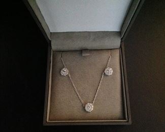 DIAMOND FLEURETTE 18 KT WHITE GOLD AND 1.64 CARAT DIAMOND NECKLACE: LOTS OF FIRE AND SPARKLE.
Signed appraisal report included. Gift Box Included.
One stamped and tested 18KT white gold lady's hand assembled three diamond cluster necklace with a shared prong set.
18KT white gold lobster clasp and bright polish finish.
Identified with markings of "18kt/750".
Condition: Excellent. Light scratches on metal.
Total Weight of Diamonds: 1.64 ct.
Total Weight of Three Diamond Cluster Necklace: 6.00 gm.
Three shared prong set round brilliant cut diamonds exact total weight of 3 stones = 0.52 ct.
Clarity: VS. Color: F. Cut: Excellent
Twenty-four shared prong set round brilliant cut diamonds exact total weight 24 stones = 1.12ct.
Clarity VS. Color: F-G. Cut: Excellent.
Price: $2,900