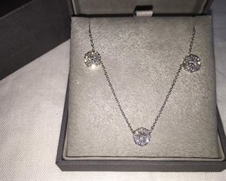 DIAMOND FLEURETTE 18 KT WHITE GOLD AND 1.64 CARAT DIAMOND NECKLACE: LOTS OF FIRE AND SPARKLE.
Signed appraisal report included. Gift Box Included.
One stamped and tested 18KT white gold lady's hand assembled three diamond cluster necklace with a shared prong set.
18KT white gold lobster clasp and bright polish finish.
Identified with markings of "18kt/750".
Condition: Excellent. Light scratches on metal.
Total Weight of Diamonds: 1.64 ct.
Total Weight of Three Diamond Cluster Necklace: 6.00 gm.
Three shared prong set round brilliant cut diamonds exact total weight of 3 stones = 0.52 ct.
Clarity: VS. Color: F. Cut: Excellent
Twenty-four shared prong set round brilliant cut diamonds exact total weight 24 stones = 1.12ct.
Clarity VS. Color: F-G. Cut: Excellent.
Price: $2,900