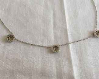 DIAMOND FLEURETTE 18 KT WHITE GOLD AND 1.64 CARAT DIAMOND NECKLACE: LOTS OF FIRE AND SPARKLE.
Signed appraisal report included. Gift Box Included.
One stamped and tested 18KT white gold lady's hand assembled three diamond cluster necklace with a shared prong set.
18KT white gold lobster clasp and bright polish finish.
Identified with markings of "18kt/750".
Condition: Excellent. Light scratches on metal.
Total Weight of Diamonds: 1.64 ct.
Total Weight of Three Diamond Cluster Necklace: 6.00 gm.
Three shared prong set round brilliant cut diamonds exact total weight of 3 stones = 0.52 ct.
Clarity: VS. Color: F. Cut: Excellent
Twenty-four shared prong set round brilliant cut diamonds exact total weight 24 stones = 1.12ct.
Clarity VS. Color: F-G. Cut: Excellent.
Price: $2,900