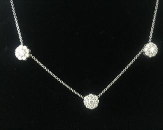 DIAMOND FLEURETTE 18 KT WHITE GOLD AND 1.64 CARAT DIAMOND NECKLACE: LOTS OF FIRE AND SPARKLE.
Signed appraisal report included. Gift Box Included.
One stamped and tested 18KT white gold lady's hand assembled three diamond cluster necklace with a shared prong set.
18KT white gold lobster clasp and bright polish finish.
Identified with markings of "18kt/750".
Condition: Excellent. Light scratches on metal.
Total Weight of Diamonds: 1.64 ct.
Total Weight of Three Diamond Cluster Necklace: 6.00 gm.
Three shared prong set round brilliant cut diamonds exact total weight of 3 stones = 0.52 ct.
Clarity: VS. Color: F. Cut: Excellent
Twenty-four shared prong set round brilliant cut diamonds exact total weight 24 stones = 1.12ct.
Clarity VS. Color: F-G. Cut: Excellent.
Price: $2,900