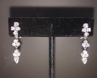 1.96 CARAT DIAMONDS AND 18K WHITE GOLD SWING DROP EARRINGS: LOTS OF FIRE AND SPARKLE.
One pair stamped & tested 18KT white gold lady's hand assembled diamond swing drop earrings.
Prong set, omega clip backs with posts and a bright polish finish Identified with markings of "18kt/750".
Condition: Excellent. Light scratches on metal.
Signed Appraisal Report included.
Total weight of diamonds: 1.96 ct.
Total weight of diamond drop earrings: 5.60 grams
Contains: Two prong set pear shaped cut diamonds (depth est.) exact total weight 2 stones = 0.41 ct. Clarity SI1 Color G Cut Excellent.
Twenty prong set round brilliant cut diamonds exact total weight 20 stones = 1.55 ct. Clarity SI-1. Color F-G. Cut: Excellent. Length of earring: Approximately One and one-quarter inch.
Width of earring: Approximately 1/4 inch at its widest.
Gift Box Included.
Price: $3,700.