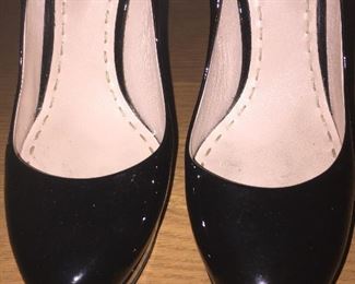 MIU MIU BLACK PATENT LEATHER PLATFORM PUMPS: Size 37. Heel Height: 5 inches. Platform Height: 1 inch. Price: $100.