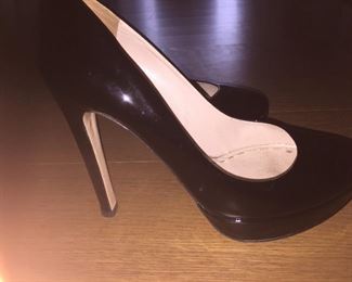 MIU MIU BLACK PATENT LEATHER PLATFORM PUMPS: Size 37. Heel Height: 5 inches. Platform Height: 1 inch. Price: $100.