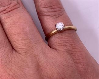 14K gold and diamond solitaire ring.