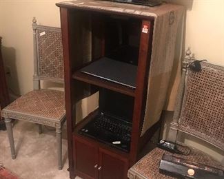 Flat screen TV and two caned chairs
