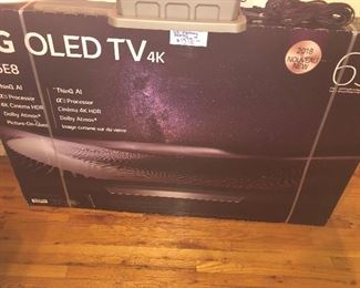 CLOSE OF VIEW OF NEW FACTORY SEALED BOX OF LG OLED TV WITH RARE 4 K - 65 INCHES