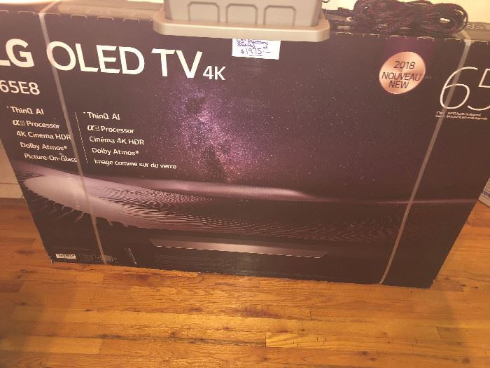 CLOSE OF VIEW OF NEW FACTORY SEALED BOX OF LG OLED TV WITH RARE 4 K - 65 INCHES