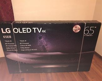 CLOSE OF VIEW OF NEW FACTORY SEALED BOX OF LG OLED TV WITH RARE 4 K - 65 INCHES