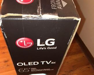 CLOSE OF VIEW OF NEW FACTORY SEALED BOX OF LG OLED TV WITH RARE 4 K - 65 INCHES