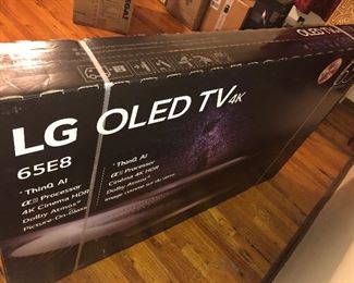 CLOSE OF VIEW OF NEW FACTORY SEALED BOX OF LG OLED TV WITH RARE 4 K - 65 INCHES