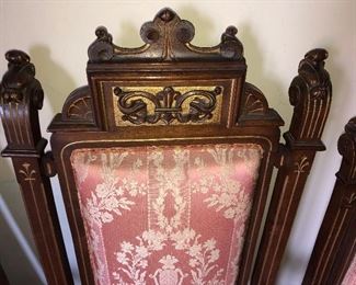 CLOSE UP VIEW OF UPPER DETAILS OF MUSEUM QUALITY CHAIR WITH ORNATE DECORATIONS AN EXTREMELY RARE JOHN HERTER VICTORIAN PARLOR SUITE CIRCA 1870 OF CARVED WALNUT & GOLD PAINTED ADORNMENT DECORATIONS -A 7 PIECE SET INCLUDING SOFA, 2 ARM CHAIRS, 4 CHAIRS.  