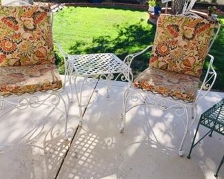 Pair of wrought iron chairs, cushions included