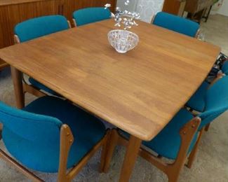 Teak Dining Table with 2 concealed boards. 8 Dining Chairs (2 arm and 6 sides).  Oddense Maskinsnedkeri chairs