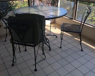 Very nice wrought iron table and 4 chairs.  Pads are included.