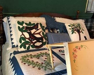 Full size bed with quilt and bedding