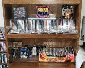 Book Case w/ Drop Down Desk  holding lots of CD's and Cassettes and Books
