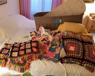 4 Afghans and two blankets with large storage tub with lid