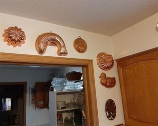 All plates and jello molds hanging in kitchen