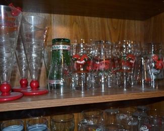 Large selection of Coca Cola beverage glasses.
